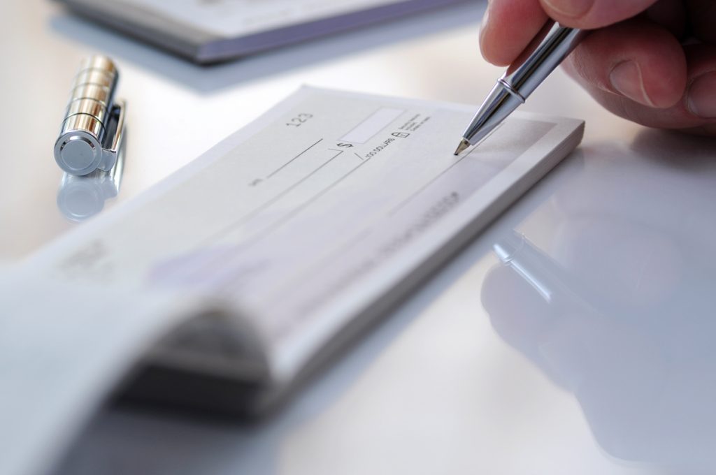 Businessman prepare writing check in the office