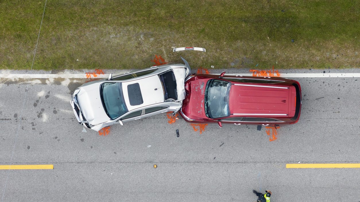 Car crash with two vehicles collided at traffic accident site on American street.