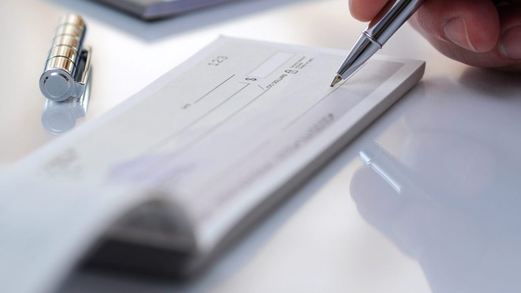 Businessman prepare writing check in the office